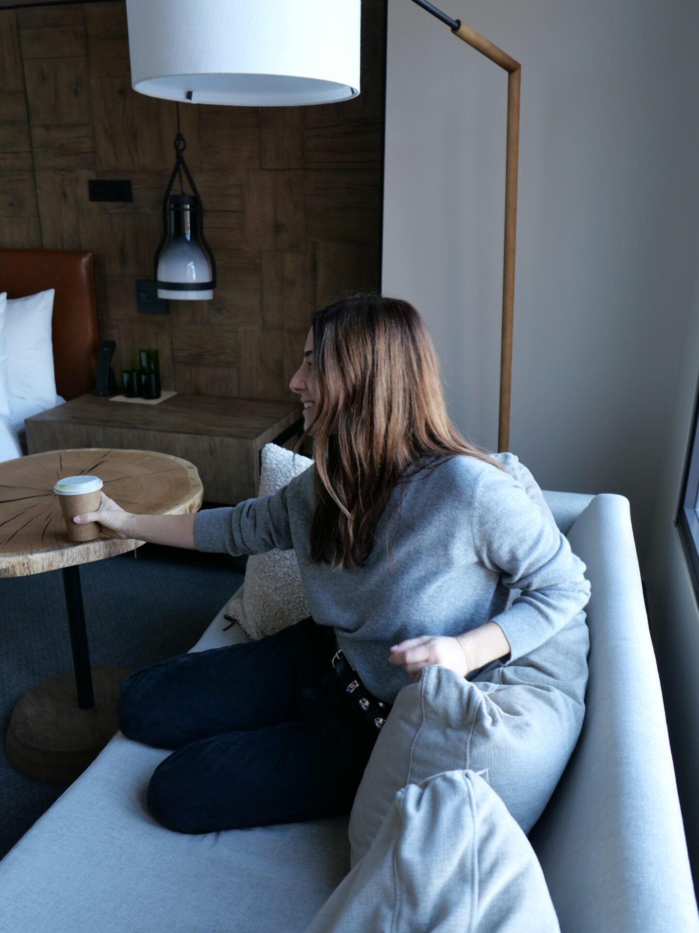 woman drinking her coffee in her hotel room at 1 Hotel San Francisco