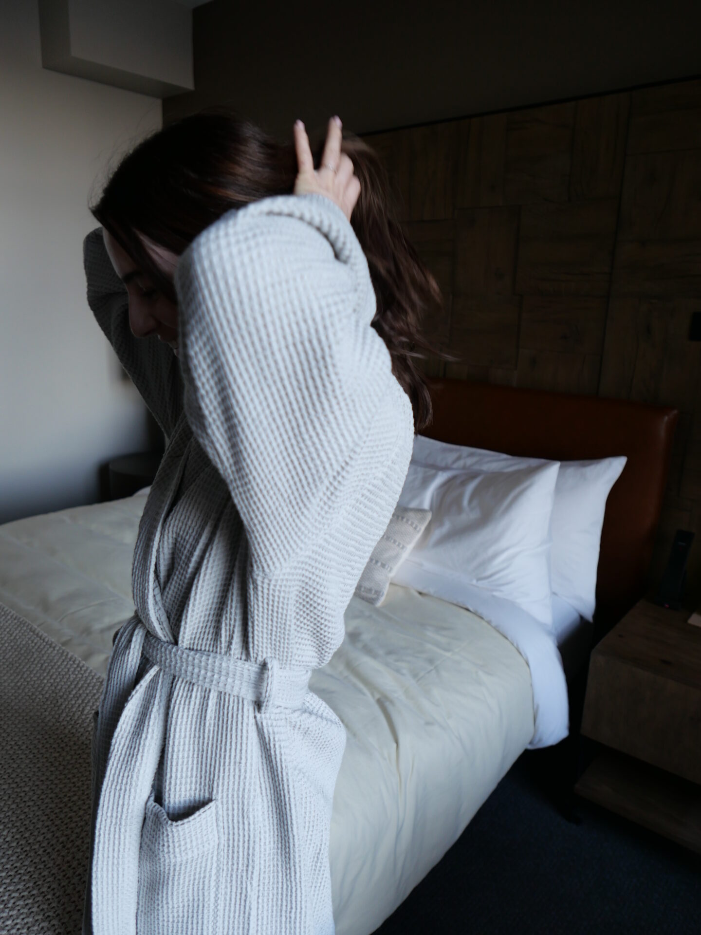 woman in a robe in her room in 1 Hotel San Francisco