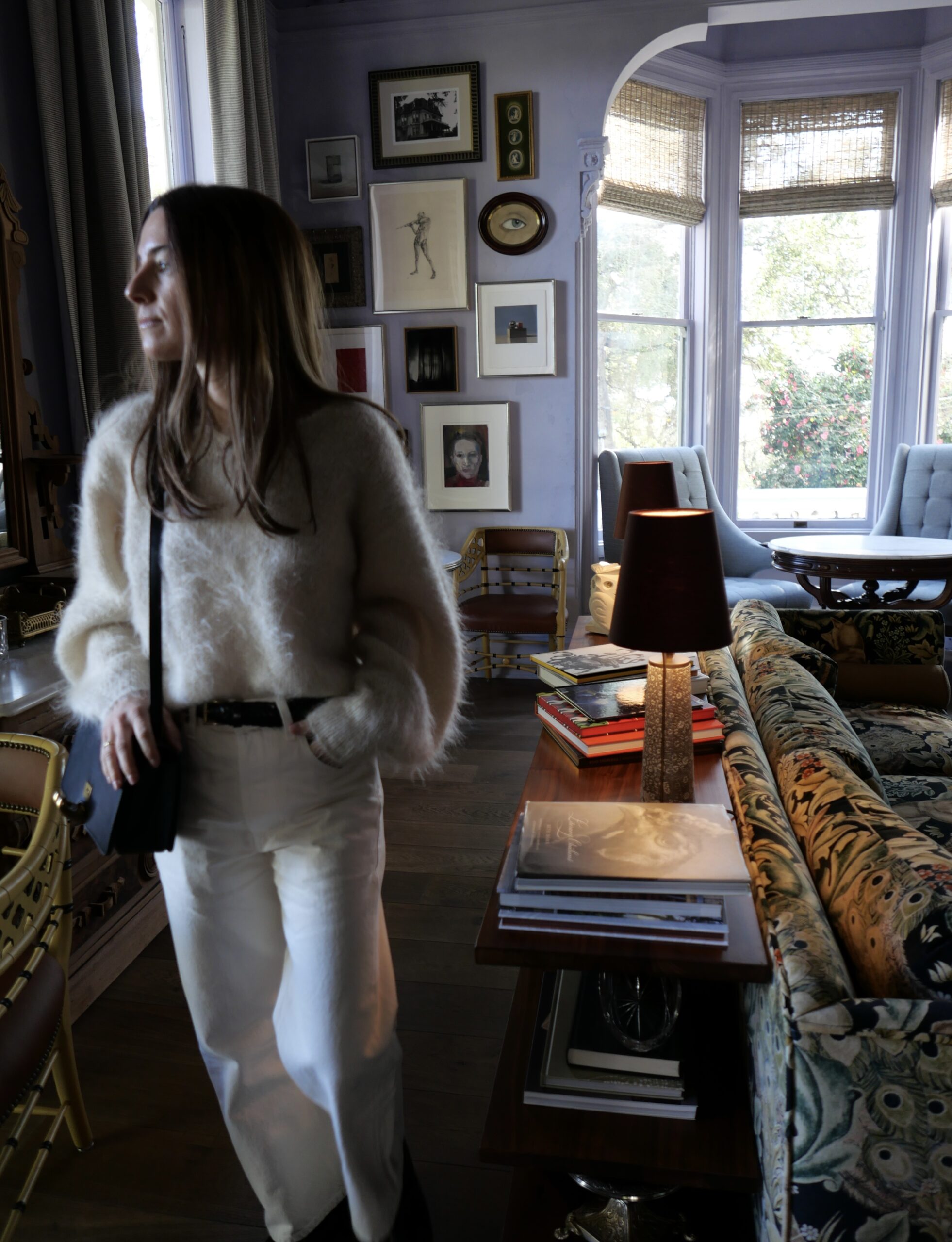 The lounge area at The Madrona Inn is a cozy and inviting space with art-filled walls.