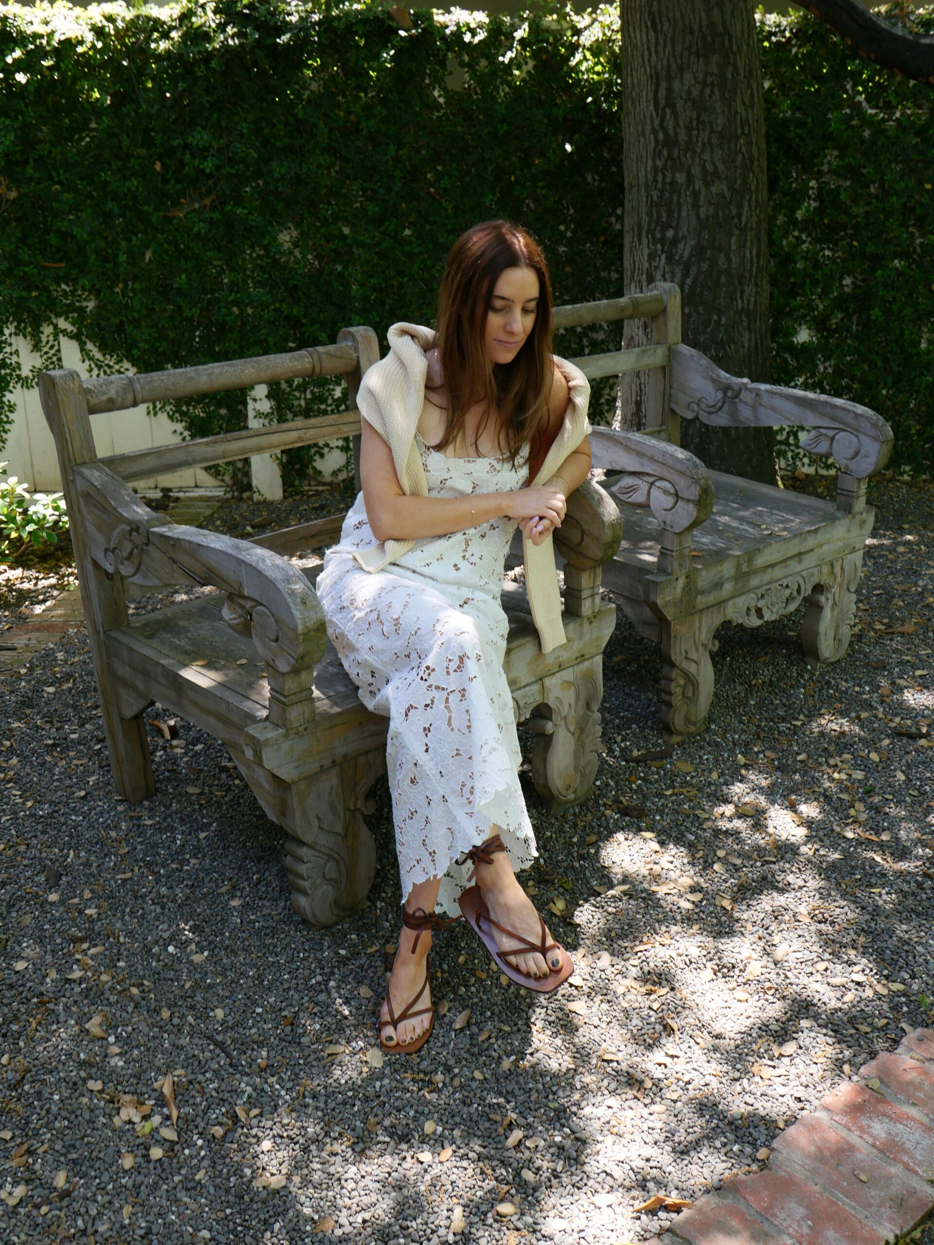 woman sitting and wearing a white lace