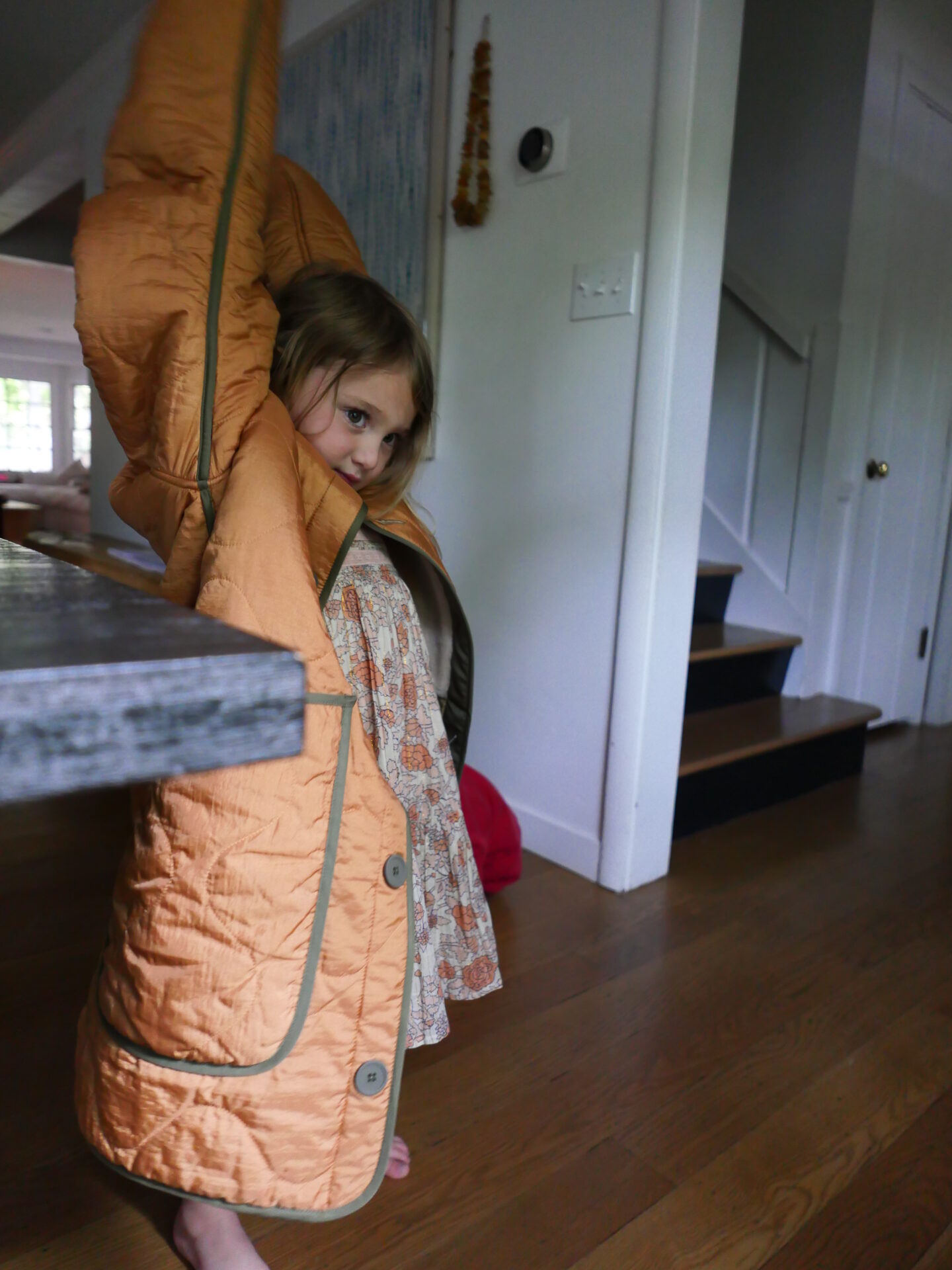 child wearing orange jacket 