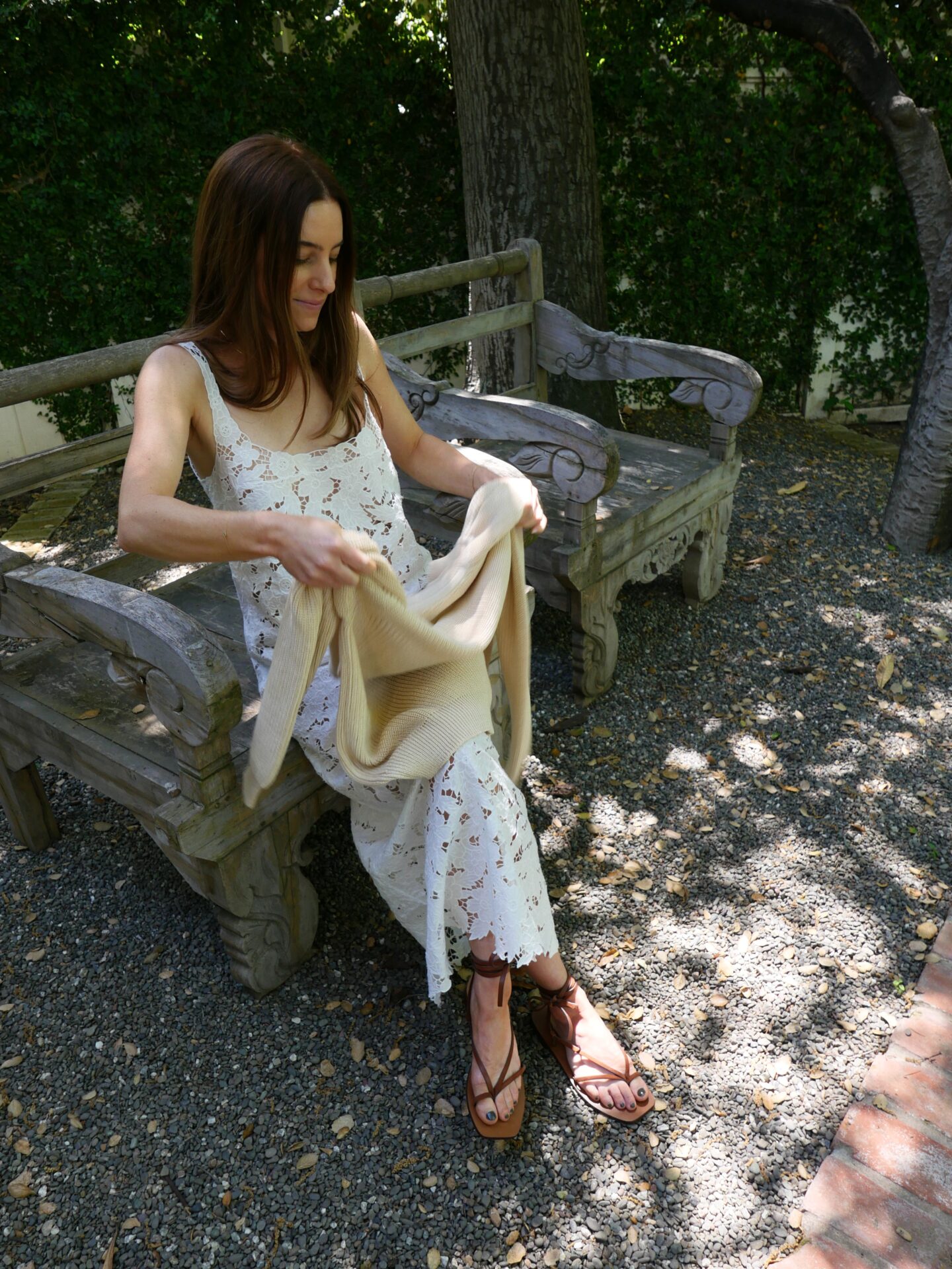 woman sitting and wearing white lace dress