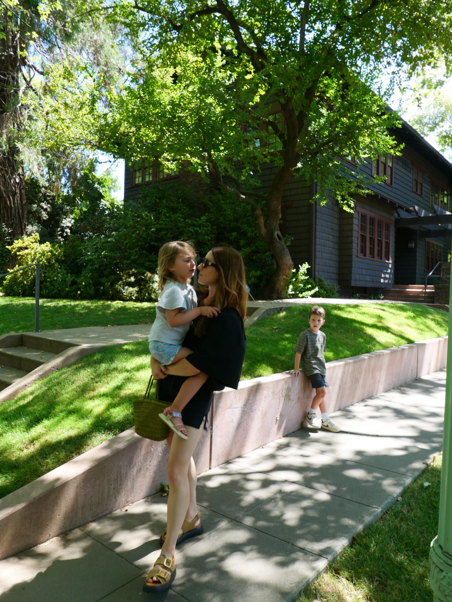 Alicia Lund wearing Flatform Sandals and carrying her kid