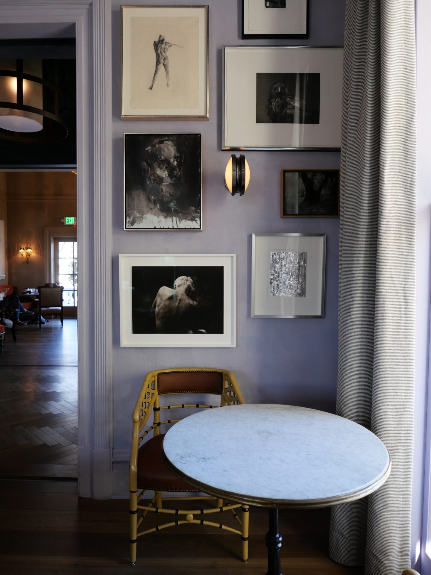 The lounge area at The Madrona Inn is a cozy and inviting space with art-filled walls.