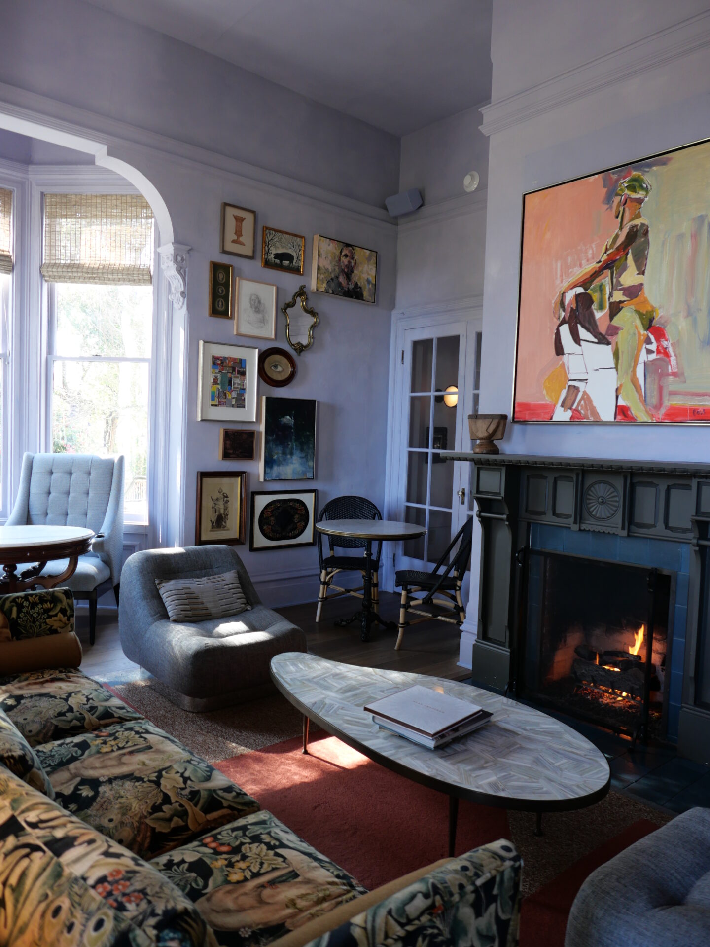 The lounge area at The Madrona Inn is a cozy and inviting space with art-filled walls.