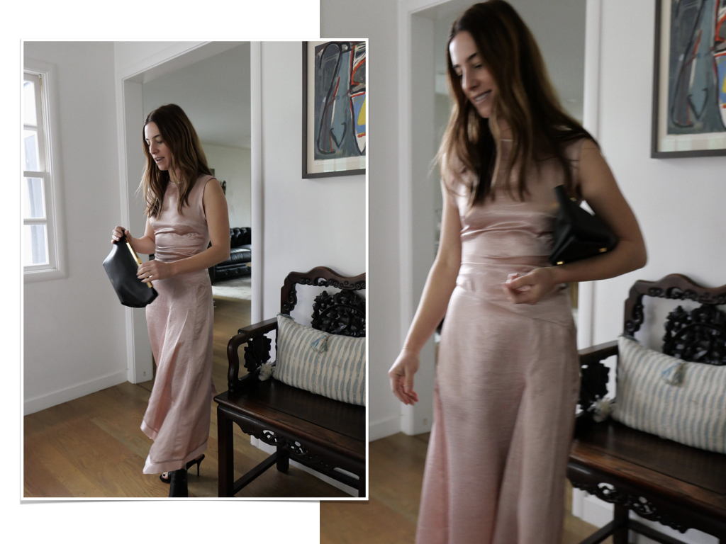 A woman wearing an Acne pale pink fitted dress with black slingback heels and black clutch.