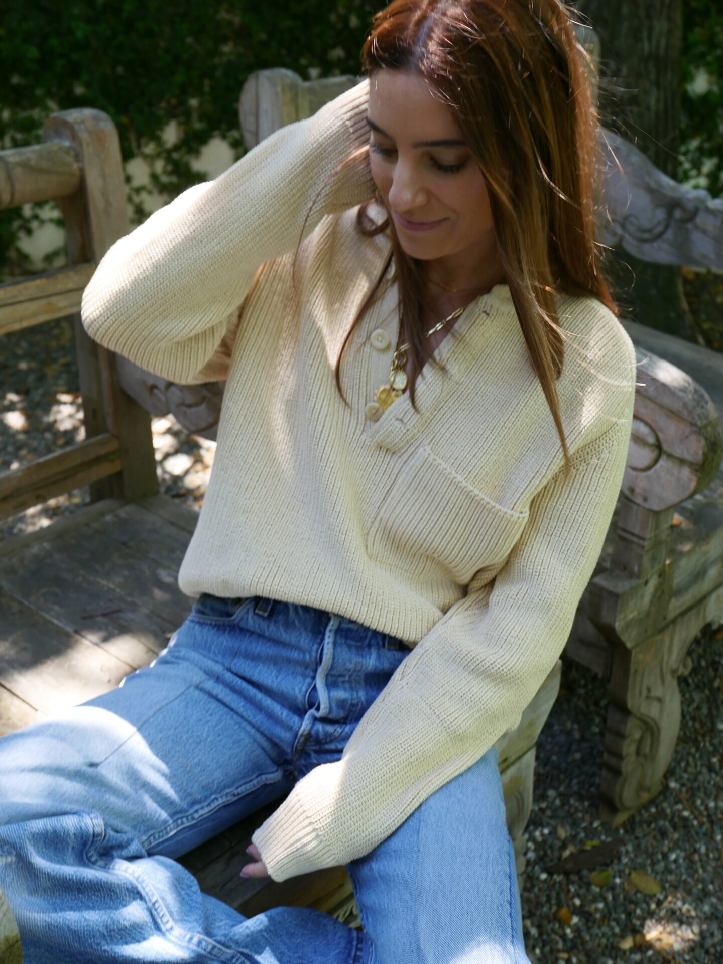 woman in Shaina Mote sweater and denim jeans 