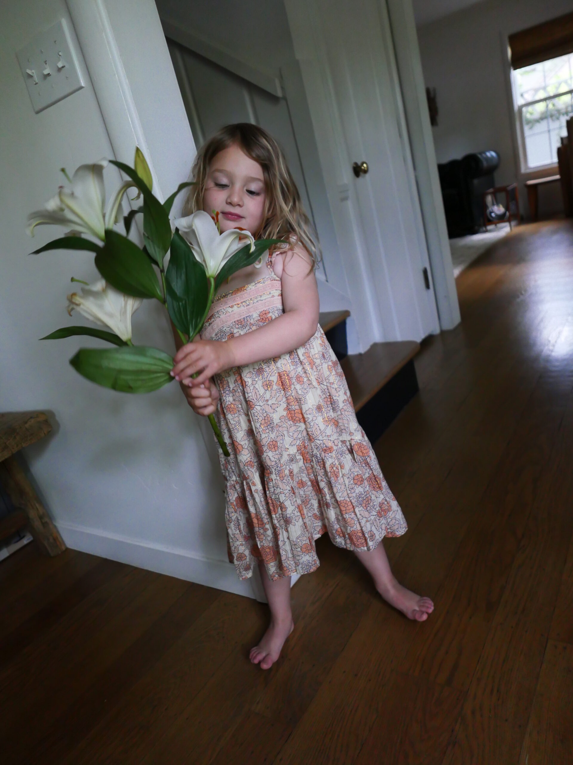 child holding flower for Mid-Week Mood Boost