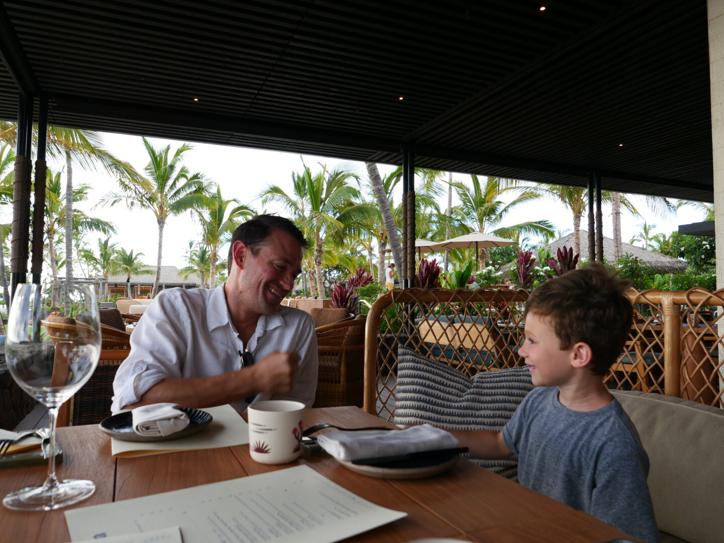 father and son dining in a restaurant in Kona Village