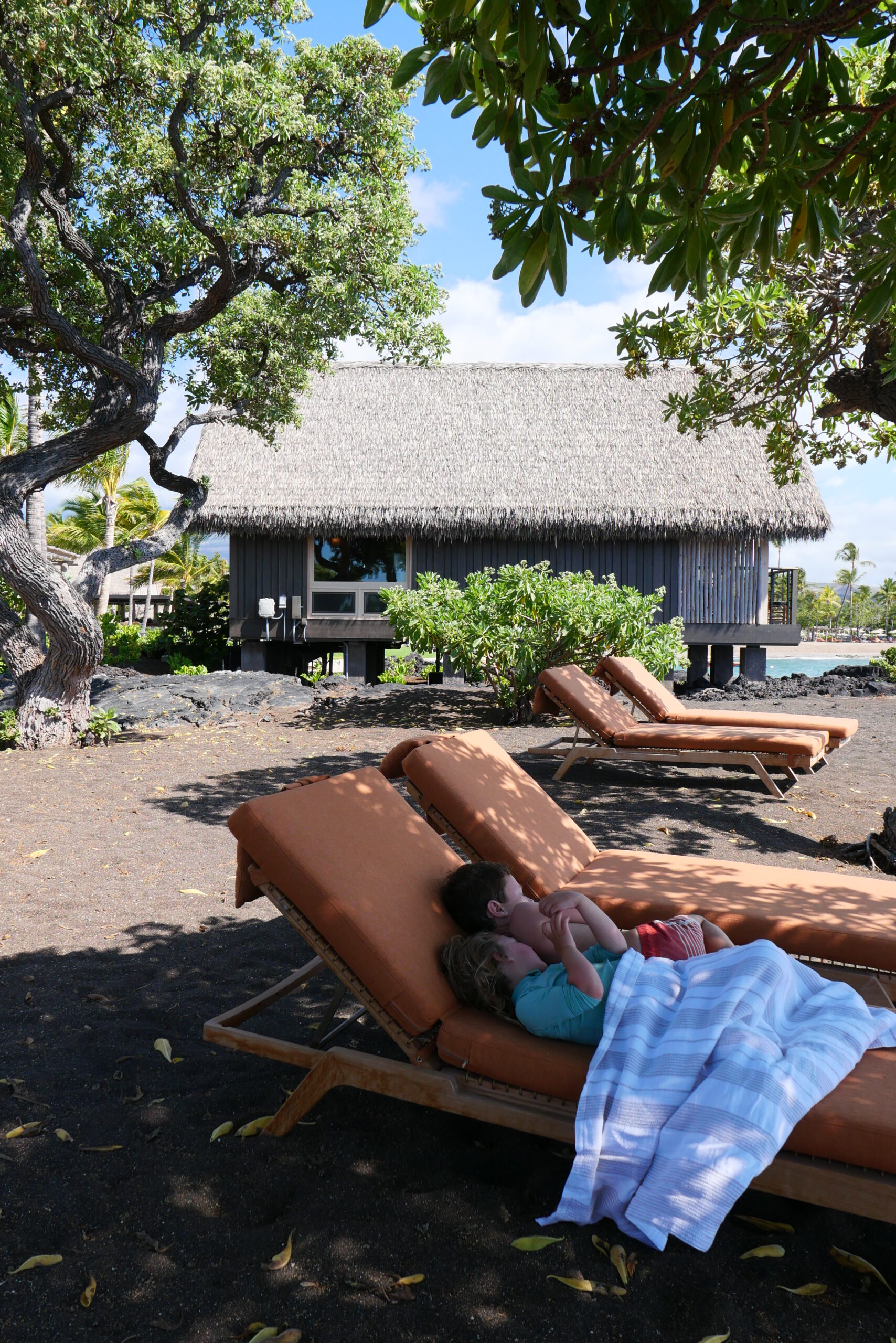 two kids taking a nap at Kona Village