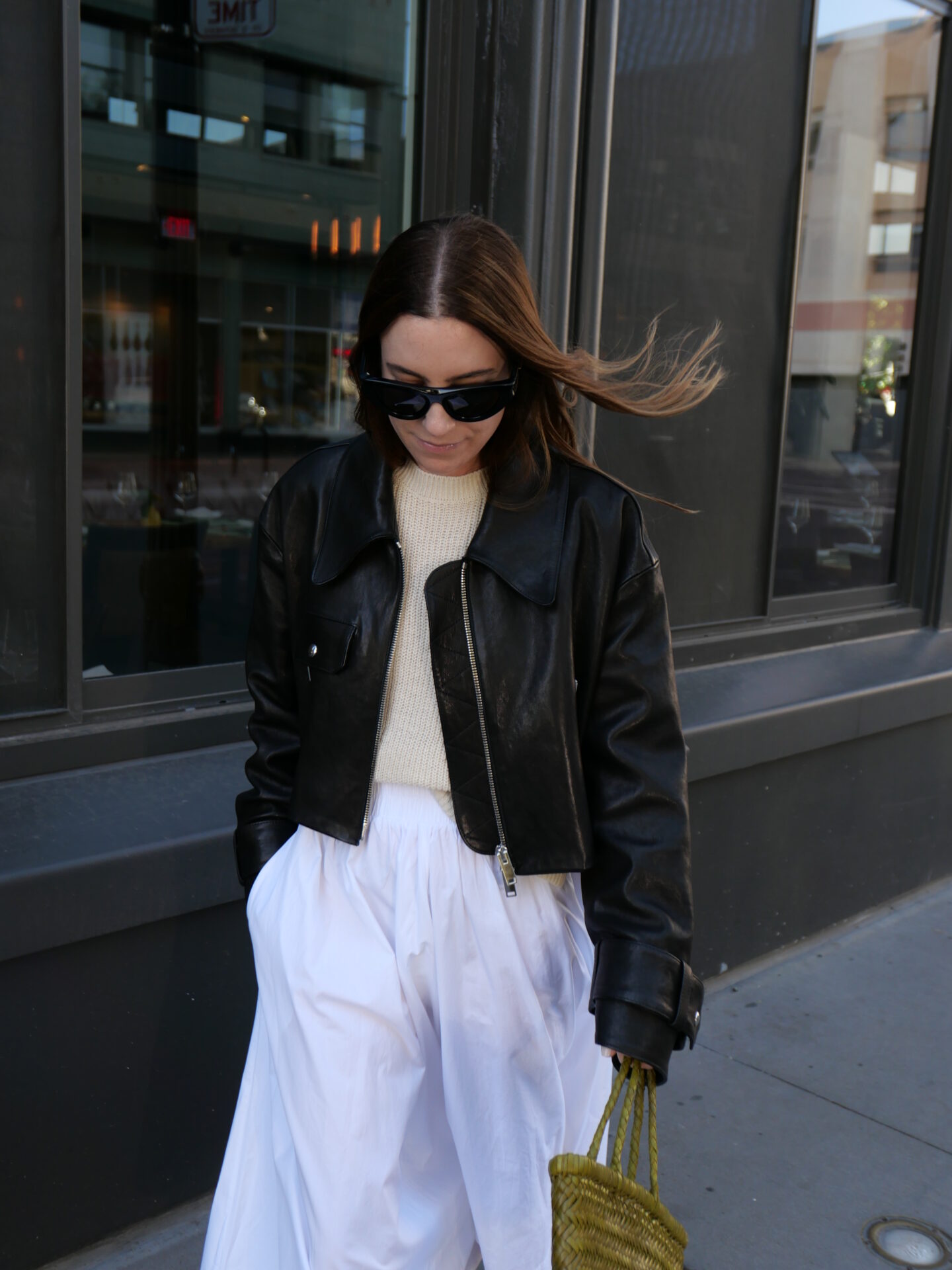 leather jacket over sweater and dress